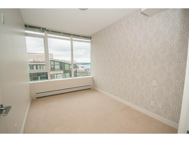 Bright living room with city view and patterned wallpaper. - 1105 - 175 West 2nd Street, North Vancouver