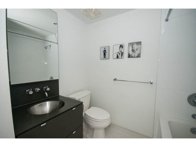 Bright bathroom with dark countertop and white fixtures. - 1501 - 1252 Hornby, Vancouver Downtown