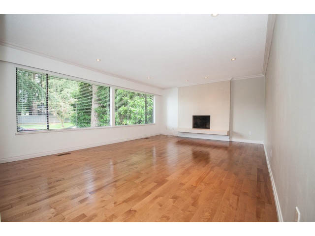 Bright living room with hardwood floors and large windows. - Upper - 1998 Cortell St., North Vancouver