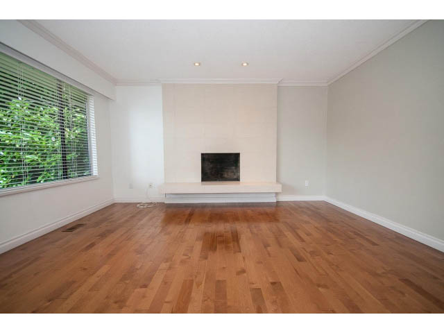 Spacious living room with hardwood floors and large window view. - Upper - 1998 Cortell St., North Vancouver