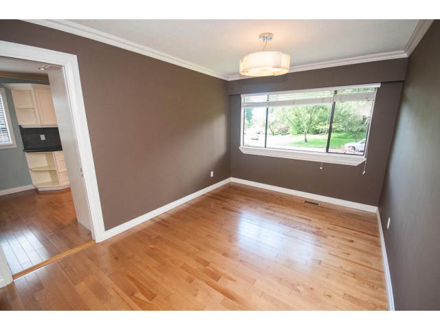 Bright living room with hardwood floors and large window view. - Upper - 1998 Cortell St., North Vancouver