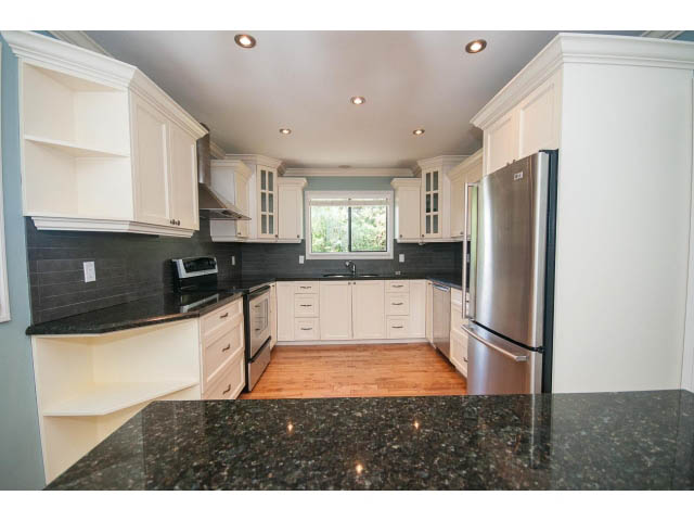 Bright kitchen with granite countertops and hardwood floors. - Upper - 1998 Cortell St., North Vancouver