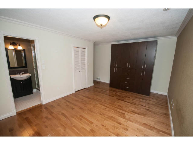 Bright kitchen with dark cabinets and hardwood floors. - Upper - 1998 Cortell St., North Vancouver
