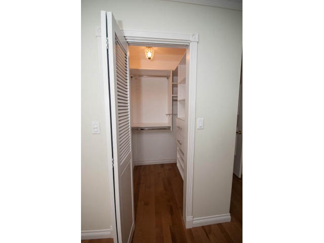 Furnished closet with white louvered doors and hardwood floors. - Upper - 1998 Cortell St., North Vancouver