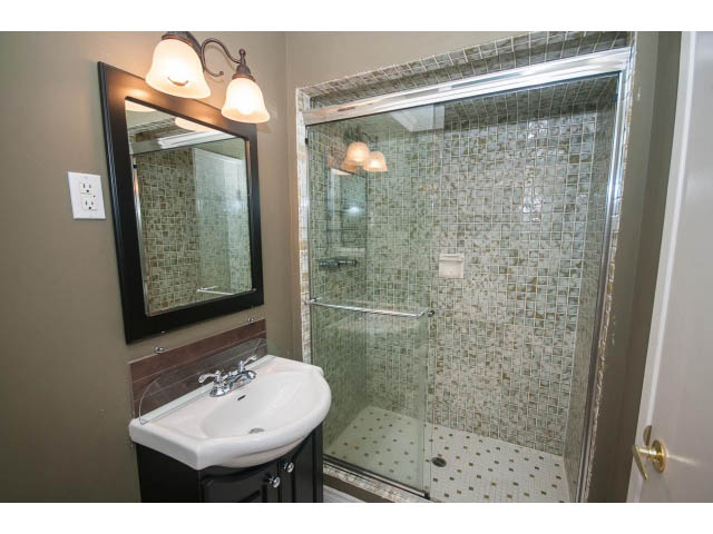Bathroom with mosaic tile shower and sink, modern design. - Upper - 1998 Cortell St., North Vancouver