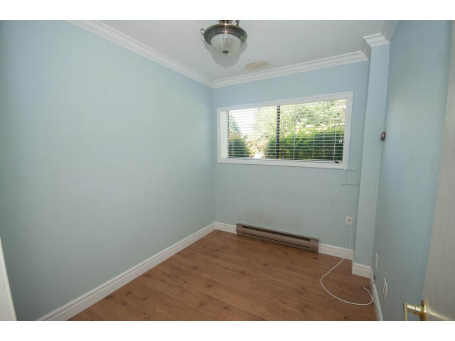 Den with hardwood floors and a window view. - Upper - 1998 Cortell St., North Vancouver