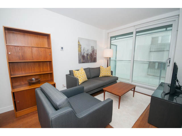 Bright living room with city view, modern furniture, and hardwood floors. - 1002 - 777 Richards, Vancouver Downtown