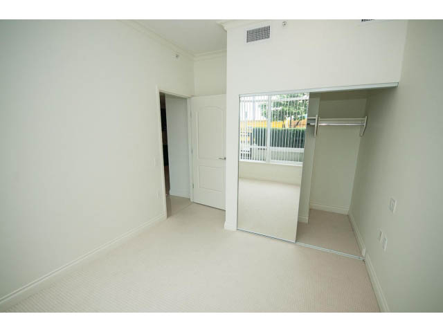 Bright bedroom with built-in closet and large window view. - 203 - 162 Victory Ship Way, North Vancouver