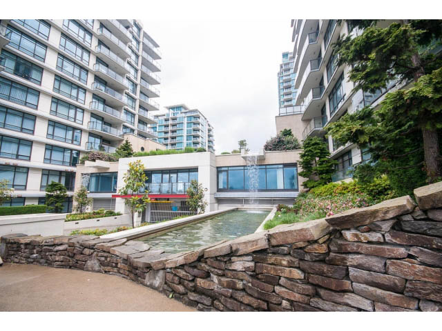 Furnished 1-bedroom condo with stone wall and garden view. - 203 - 162 Victory Ship Way, North Vancouver