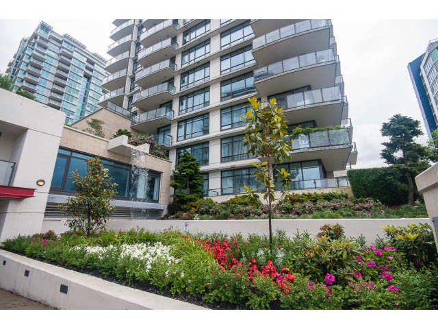 Furnished 1-bedroom condo with balcony, city view, and lush garden. - 203 - 162 Victory Ship Way, North Vancouver