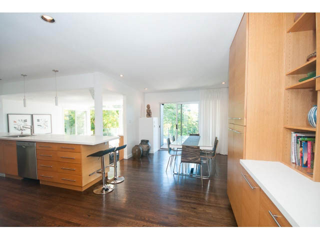 Bright kitchen with white countertops, hardwood floors, and a city view. - 6190 Candia Place, West Vancouver