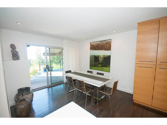 Bright kitchen with white countertops, hardwood floors, and a city view. - 6190 Candia Place, West Vancouver