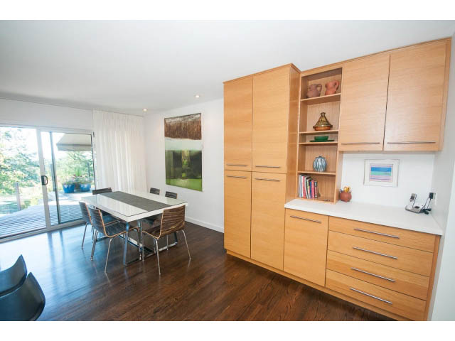 Bright kitchen with light wood cabinets, white countertops, and hardwood floors, featuring a city view. - 6190 Candia Place, West Vancouver