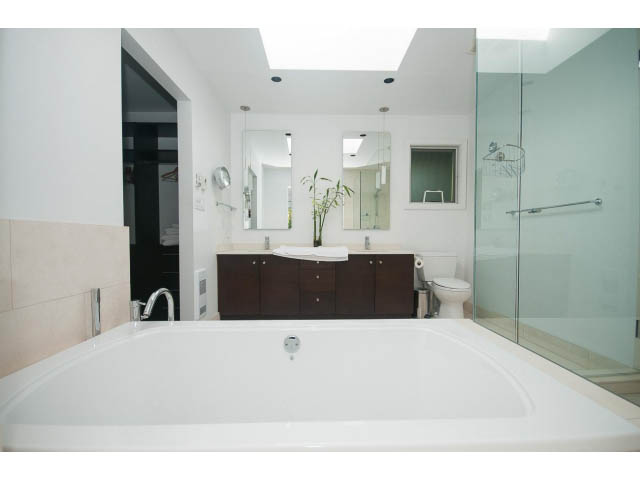Spacious bathroom with modern fixtures and large mirror. - 6190 Candia Place, West Vancouver