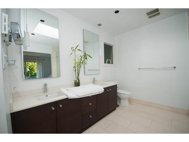 Spacious bathroom with dual sinks, large mirror, and modern fixtures. - 6190 Candia Place, West Vancouver