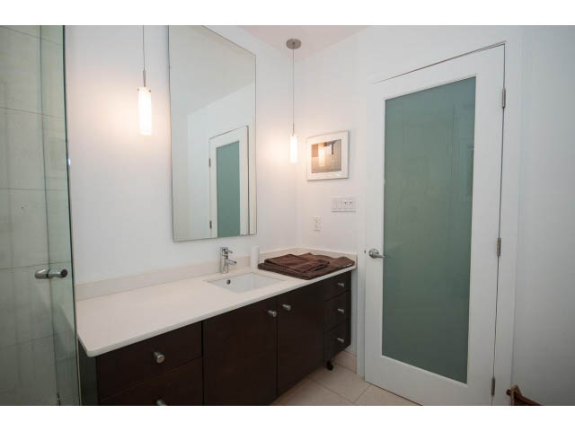 Furnished bathroom with white countertops and dark wood cabinets. - 6190 Candia Place, West Vancouver