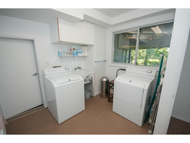 Laundry room with white appliances and large window. - 6190 Candia Place, West Vancouver