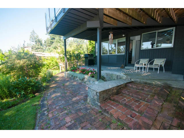 Furnished patio with brick flooring, outdoor seating, and garden view. - 6190 Candia Place, West Vancouver