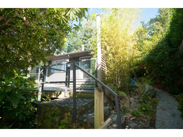 Furnished patio with stone steps and lush greenery. - 6190 Candia Place, West Vancouver