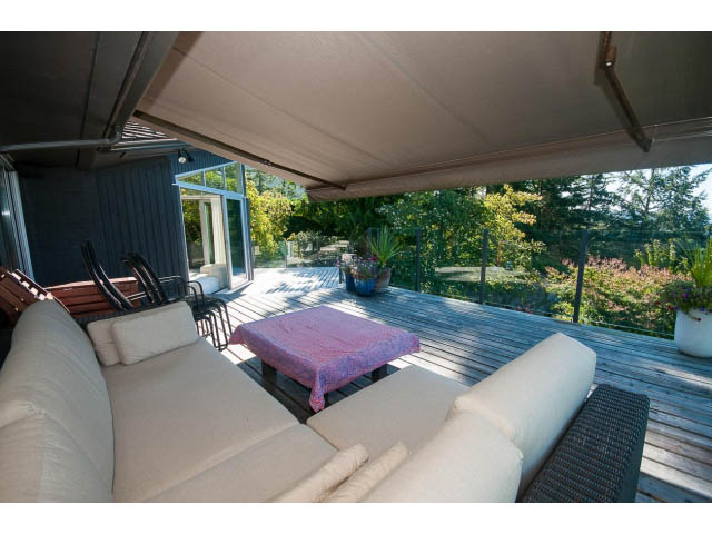 Furnished living room with outdoor deck and scenic view. - 6190 Candia Place, West Vancouver