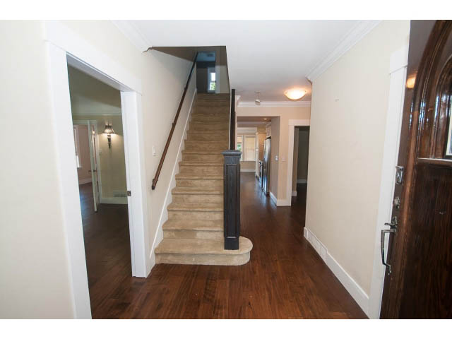 Bright hallway leading to stairs with hardwood floors and white walls. - 2939 West 30th Ave, Vancouver West Side