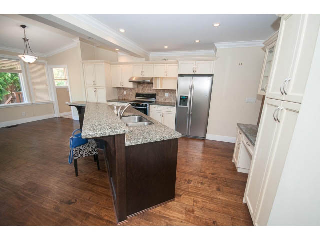 Bright kitchen with granite countertops, hardwood floors, and stainless steel appliances. - 2939 West 30th Ave, Vancouver West Side