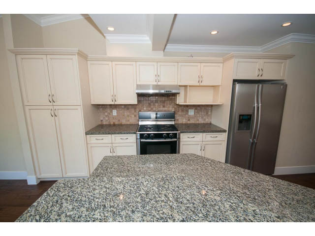 Bright kitchen with granite countertops and stainless steel appliances, hardwood floors. - 2939 West 30th Ave, Vancouver West Side