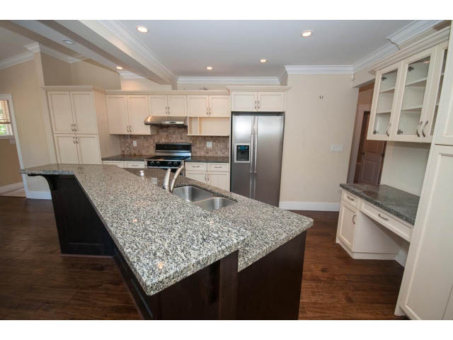 Bright kitchen with granite countertops, dark wood cabinets, and hardwood floors. - 2939 West 30th Ave, Vancouver West Side