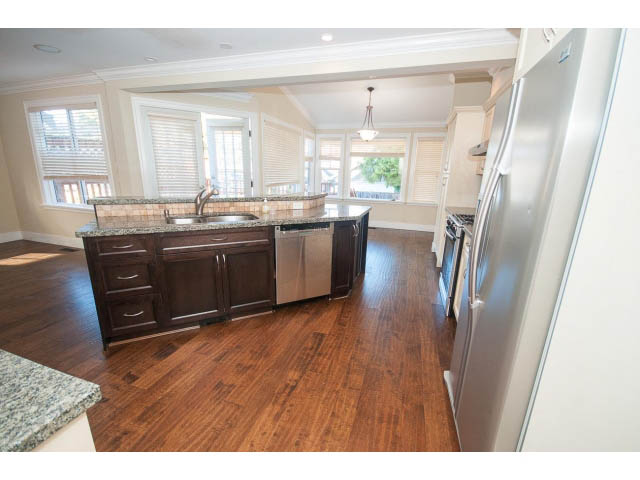 Bright kitchen with granite countertops, hardwood floors, and a city view. - 2939 West 30th Ave, Vancouver West Side