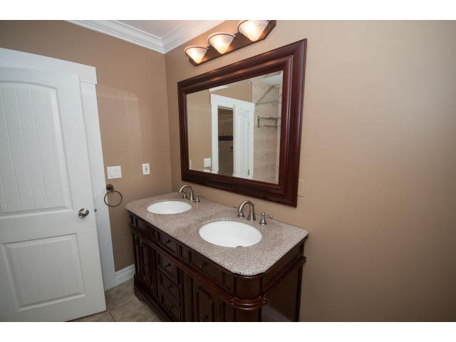 Spacious bathroom with granite countertops and dark wood cabinets. - 2939 West 30th Ave, Vancouver West Side