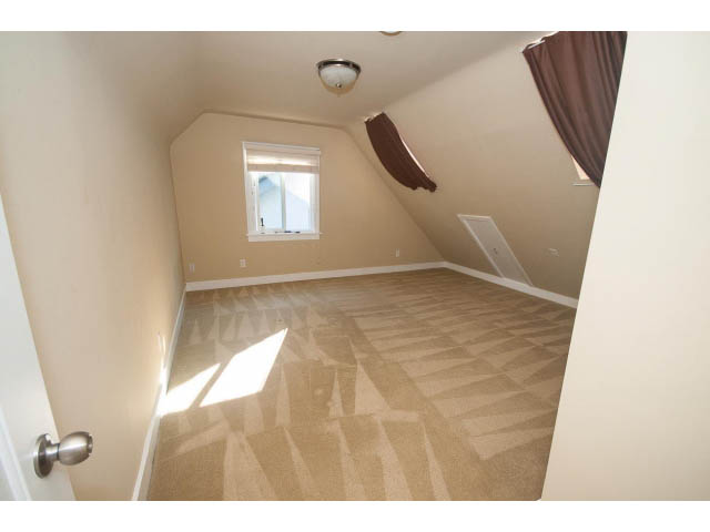 Bright attic bedroom with sloped ceiling and small window. - 2939 West 30th Ave, Vancouver West Side