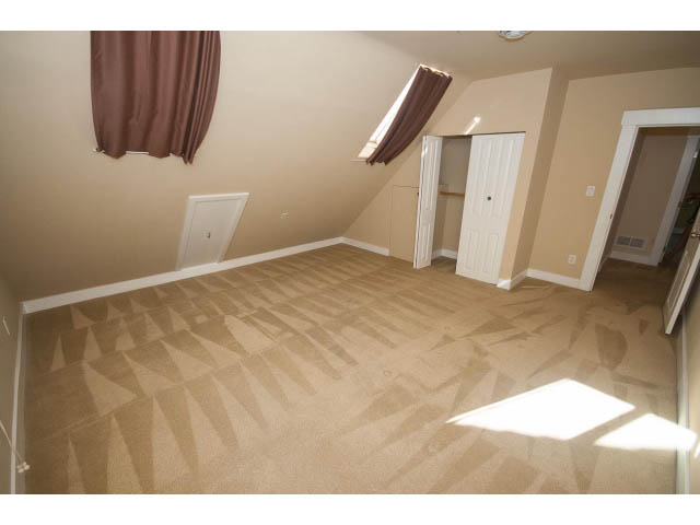 Bright bedroom with geometric carpet pattern and large windows. - 2939 West 30th Ave, Vancouver West Side