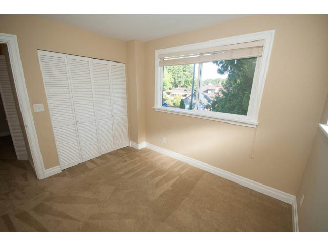 Spacious bedroom with large closet and window view of trees. - 2939 West 30th Ave, Vancouver West Side