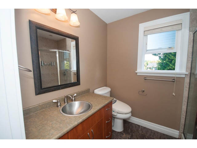 Spacious bathroom with granite countertops and a large mirror. - 2939 West 30th Ave, Vancouver West Side