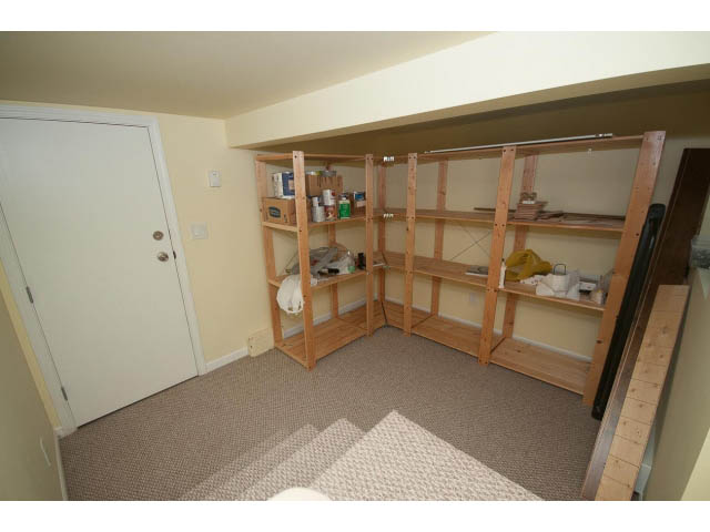 Storage area with wooden shelving and carpeted floor. - 2939 West 30th Ave, Vancouver West Side
