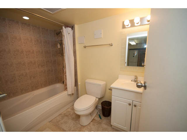 Furnished bathroom with white cabinets, countertop, and shower. - 2939 West 30th Ave, Vancouver West Side
