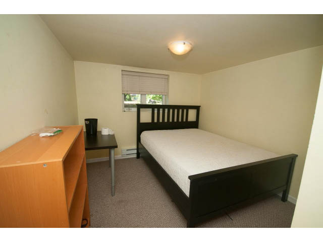 Small bedroom with a twin bed, desk, and window view. - 2939 West 30th Ave, Vancouver West Side