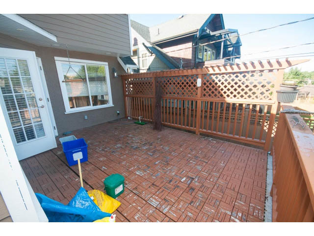 Furnished patio with wooden deck and lattice privacy screen. - 2939 West 30th Ave, Vancouver West Side