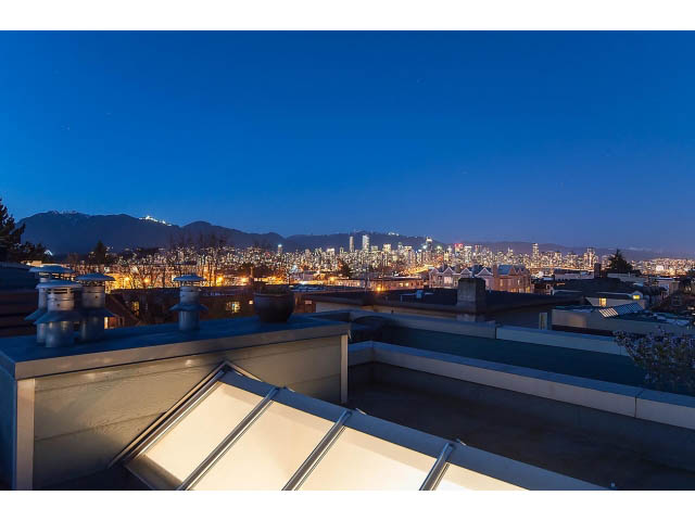 Bright rooftop living room with stunning city view and mountain backdrop. - 402 - 2252 West 5th Ave, Vancouver West Side