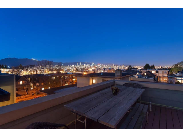 Spacious rooftop patio with stunning city view and wooden deck, perfect for relaxation. - 402 - 2252 West 5th Ave, Vancouver West Side