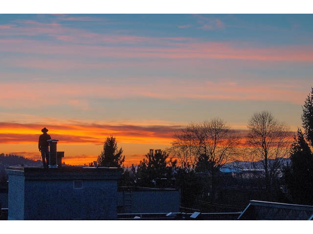 Sunset view from a 2-bedroom condo with rooftop access, featuring a stunning cityscape. - 402 - 2252 West 5th Ave, Vancouver West Side