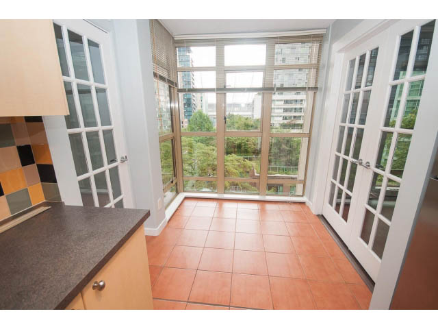 Bright kitchen with granite countertops, hardwood floors, and a city view. - 602 - 819 Hamilton Street, Vancouver Downtown