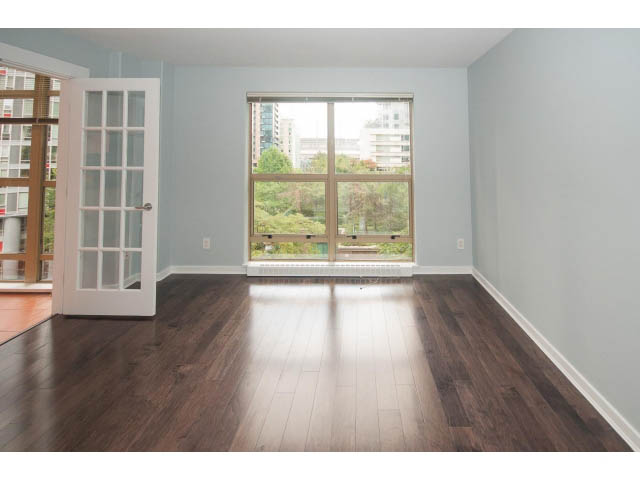 Bright living room with hardwood floors, large windows, and city view. - 602 - 819 Hamilton Street, Vancouver Downtown