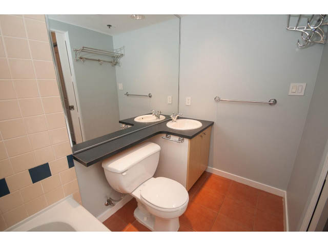 Bathroom with modern fixtures, tiled walls, and a large mirror. - 602 - 819 Hamilton Street, Vancouver Downtown