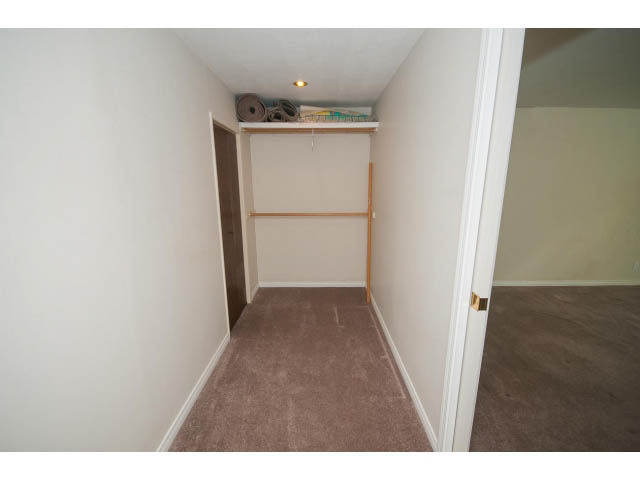 Furnished hallway with carpeted flooring and built-in shelving. - 221 Carisbrooke Crescent, North Vancouver