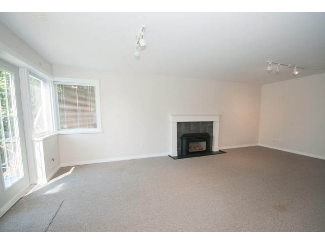 Bright living room with fireplace and large windows. - 221 Carisbrooke Crescent, North Vancouver