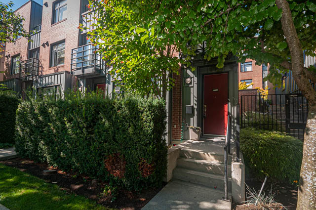 Furnished townhouse with red door and lush greenery. - 2753 Guelph Street, Vancouver East Side
