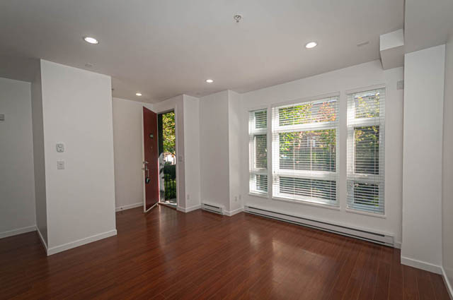Bright living room with hardwood floors and large windows. - 2753 Guelph Street, Vancouver East Side