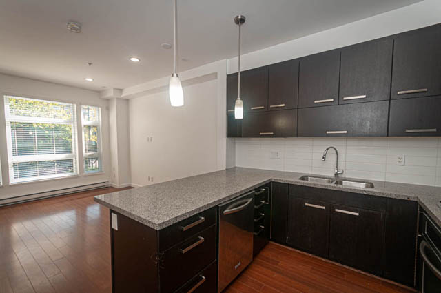 Bright kitchen with granite countertops, hardwood floors, and a city view. - 2753 Guelph Street, Vancouver East Side
