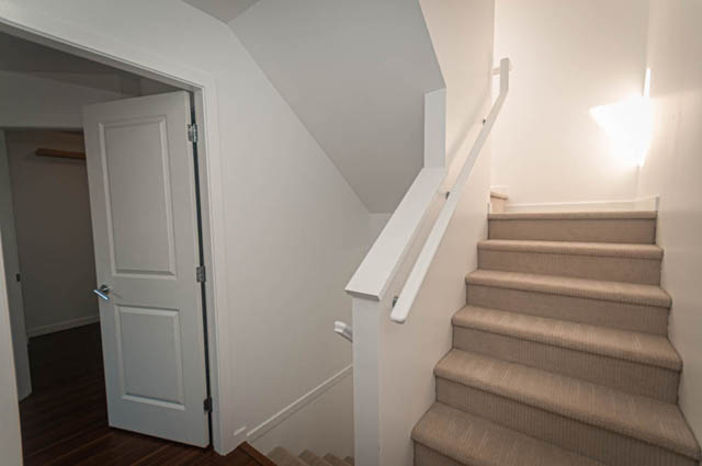 Furnished den with carpeted stairs and white walls. - 2753 Guelph Street, Vancouver East Side